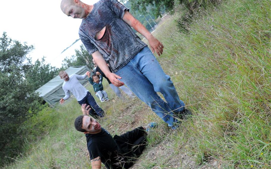 Soldiers from 4-5 ADA practice their zombie walking skills during the unit's zombie run at the Lightning Ranch at Fort Hood, Texas, on Oct. 26.