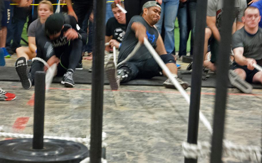 Army veteran Lyndon Sampang pulls weights toward him during the Working Wounded Games on Saturday, Nov. 2, 2013. The games were held in Vienna, Va.