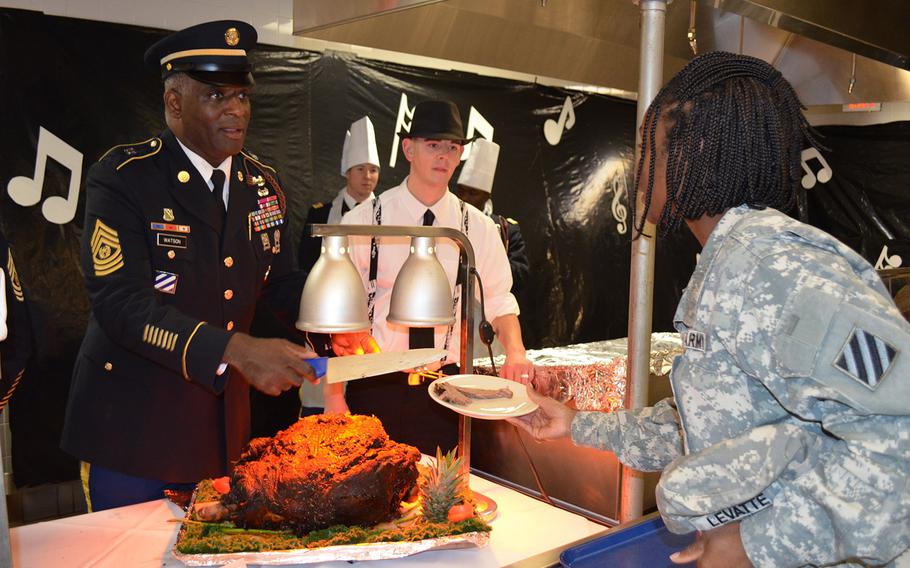 Command Sgt. Maj. Edd Watson, 3rd Infantry Division command sergeant major, serves Sgt. 1st Class Demeta Levatte, a 603rd Aviation Support Battalion soldier, a portion of her Thanksgiving lunch Nov. 27 at Hunter Army Air Field, Ga. 