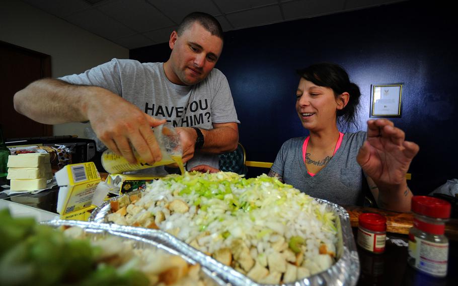 Brian Neilsen, left, and Sarah Hollister prepare stuffing for a Thanksgiving Day meal.