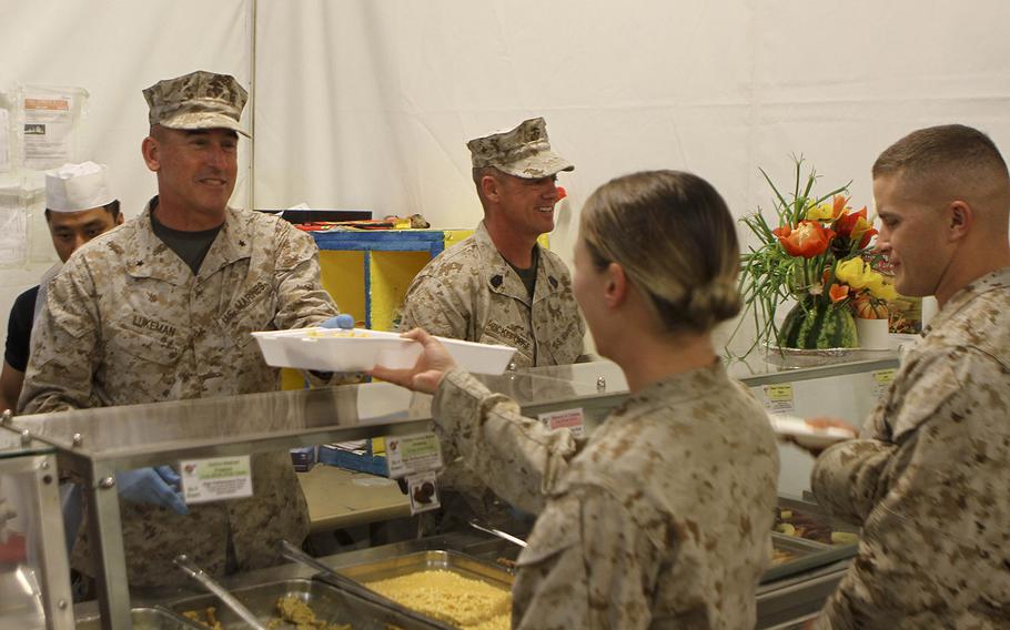 U.S. Marine Brig. Gen. James Lukeman, commanding general of 2nd Marine Division, serves a Marine in the chow hall at Camp Leatherneck, Afghanistan, Nov. 28. Even while deployed service members are still able to have a little taste of home by celebrating the holidays with a Thanksgiving meal. 