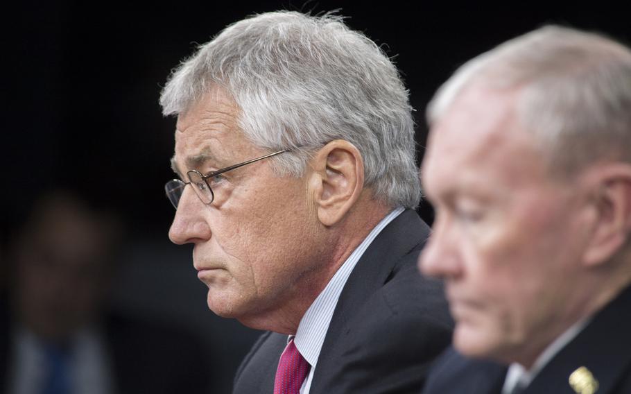 Secretary of Defense Chuck Hagel and Joint Chiefs of Staff Gen. Martin E. Dempsey brief the press at the Pentagon, Dec. 4, 2013.