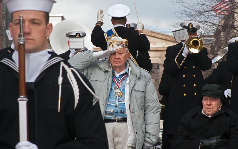 Pearl Harbor survivor STC Howard Snell stands to salute the U.S. Navy Color Guard during the Pearl Harbor Remembrance Day on Dec. 7, 2013. To the right of Snell is another Pearl Harbor survivor, Major Albert Grasselli, who was stationed at Ewa Beach Marine Airfield. 