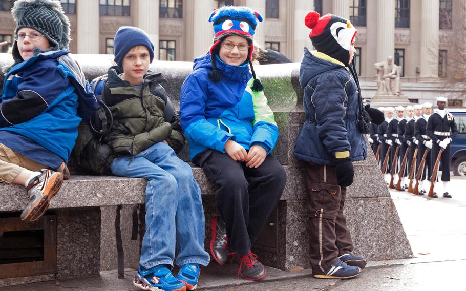 Children wait for the Pearl Harbor Remembrance Day ceremony to start in Washington, D.C.