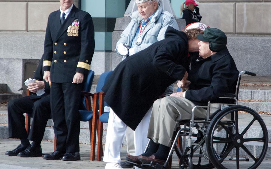 Lou Large leans in and gives Pearl Harbor survivor Major Albert Grasselli a kiss on the cheek after saying a few words to the crowd gathered for the Pearl Harbor Remembrance Day at the U.S. Navy Memorial on Dec. 7, 2013 in Washington, D.C. 