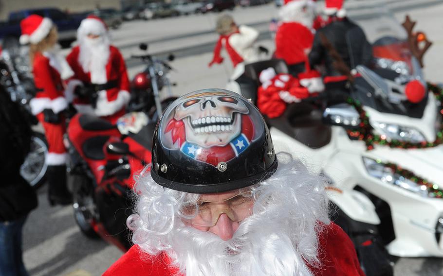 SANTA-TUDE | Larry Daniels joins over a dozen Santa Clauses as they ride their motorcycles to meet with and hand out stuffed animals to children in York, Pa., on Dec. 7, 2013.