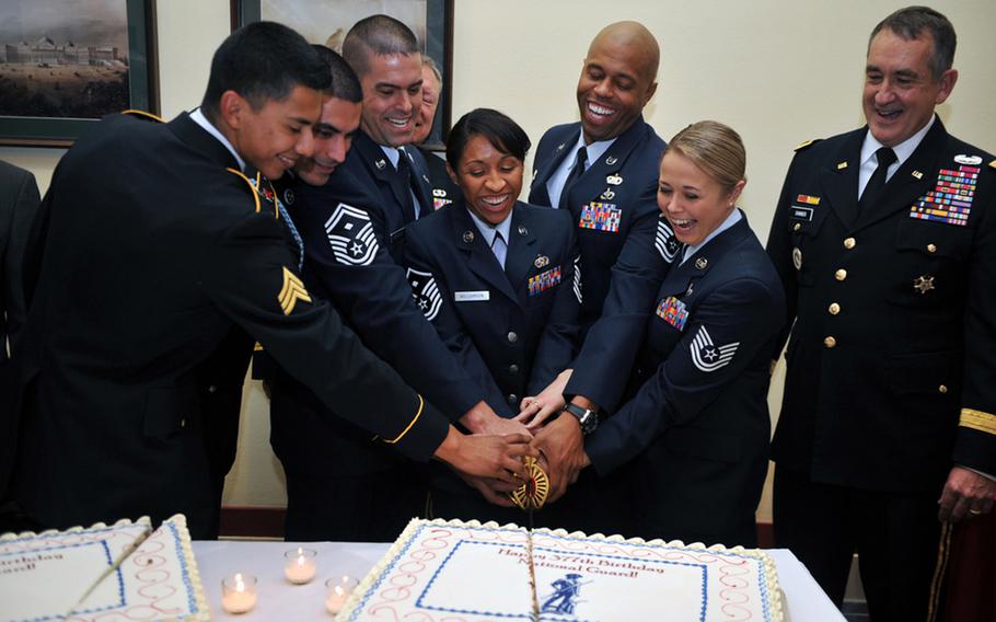 Six of the National Guard's eight 2013 Outstanding Soldiers and Airmen of the Year kick off the National Guard's 377th birthday celebrations by cutting a cake on Capitol Hill, Washington, D.C., Dec. 11, 2013. The birthday is today, December 13.