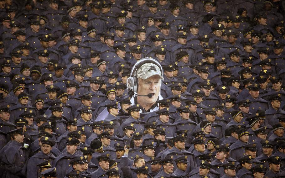 Army cadets hold a large photo of Army head coach Rich Ellerson during an NCAA college football game against Navy, on Saturday, Dec. 14, 2013, in Philadelphia. Navy won 34-7.