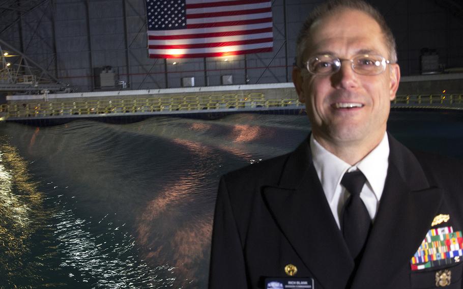 Capt. Rich Blank, commander of the Naval Surface Warfare Center's Carderock Division, stands in front of the newly-renovated Maneuvering and Seakeeping Basin