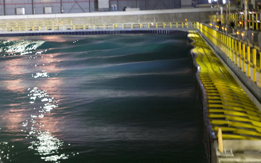 The newly-renovated Maneuvering and Seakeeping Basin at the Naval Surface Warfare 
Center's Carderock Division in Maryland. The tank, used for testing the performance of 
ship models, is larger than a football field at 360 feet by 240 feet, and holds 12 
million gallons of water. It uses 216 individually-controlled wave boards to create precise wave environments that weren't possible with the previous pneumatic system.