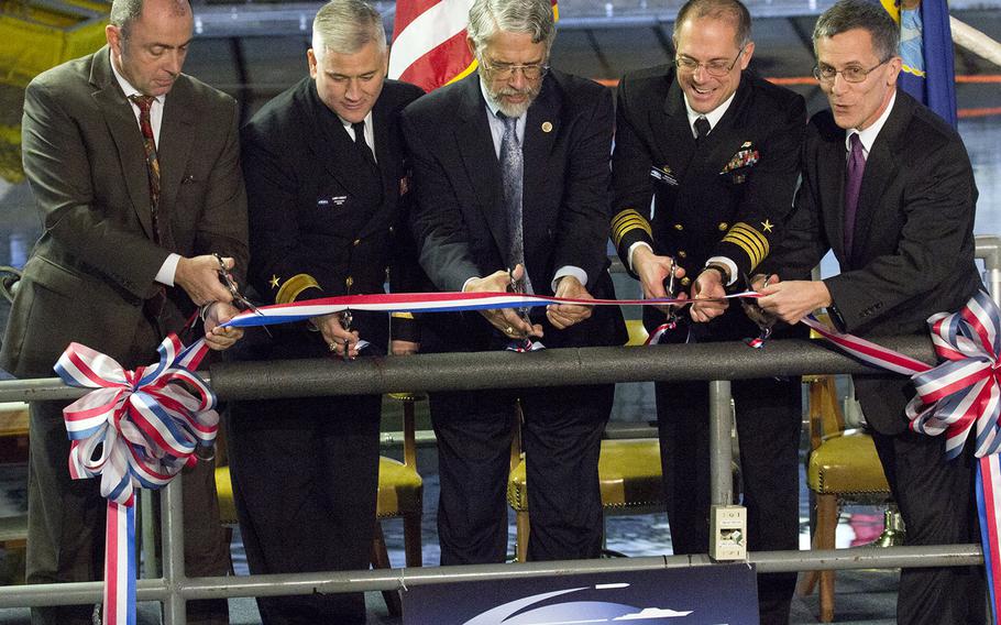 Cutting the ribbon to open the Naval Surface Warfare Center's newly-renovated Maneuvering and Seakeeping Basin are, left to right, Jon Etxegoien, head of the Naval Architecture and Engineering Division; Rear Adm. Lawrence Creevy, the center's commander; White House Office of Science and Technology Policy Director Dr. John Holdren; Carderock Division Commander Capt. Rich Blank; and Carderock Division Technical Director Dr. Tim Arcano.