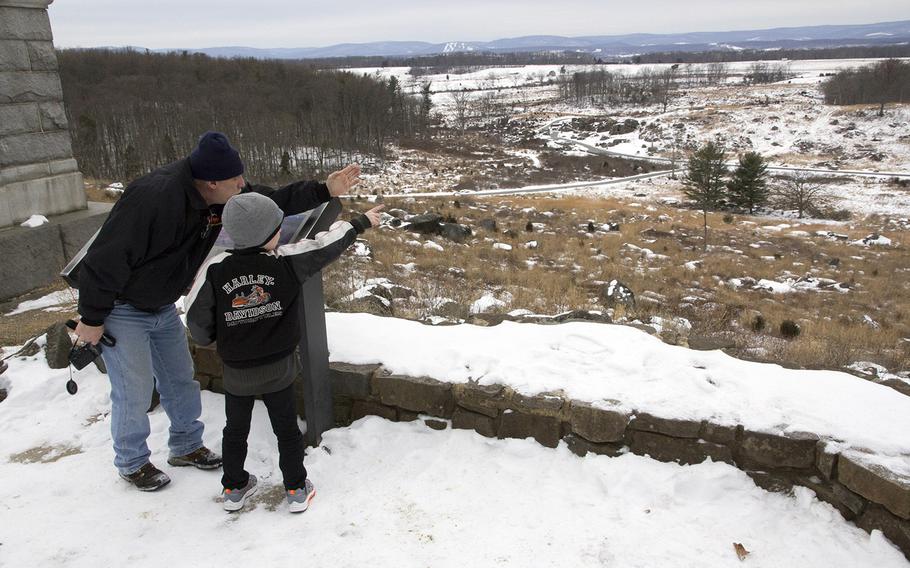 Visitors survey the winter scene at Little Round Top, Gettysburg National Military Park, January 26, 2014.