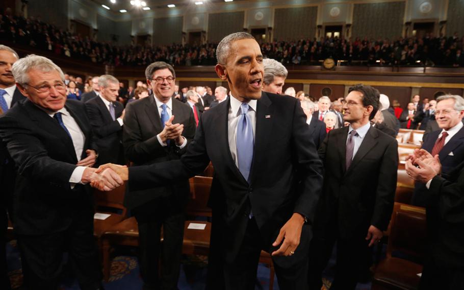 President Barack Obama shakes hands with Defense Secretary Chuck Hagel, left, as the president arrives to give his State of the Union address during a joint session of Congress on Capitol Hill in Washington on Tuesday, Jan. 28, 2014.