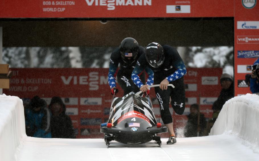 Former U.S. Army World Class Athlete Program and reigning Olympic bobsled champion driver Steven Holcomb, right, and WCAP Olympian Capt. Chris Fogt, race and eventually win the two-man bobsled event, Dec. 6, 2013, at Utah Olympic Park in Park City.