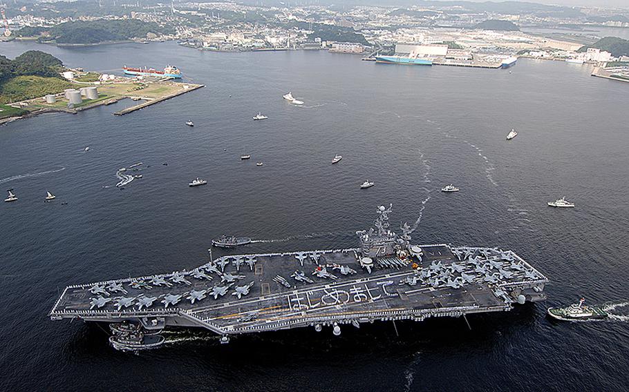 Sailors aboard the aircraft carrier USS George Washington form the phrase "Hajimemashite," which means "Nice to meet you" in Japanese, as they arrive at Fleet Activities Yokosuka, Japan on Sept. 25, 2008.