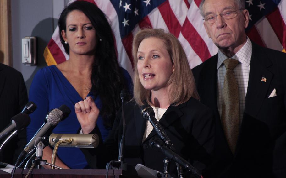 Sen. Kirsten Gillibrand (D-NY) calls for military sexual assault cases to be removed from the military chain of command on Nov. 6, 2013 in Washington, D.C. Behind her is Ariana Klay, a former Marine officer who says she was sexually assaulted, and Sen. Chuck Grassley (R-Iowa.)