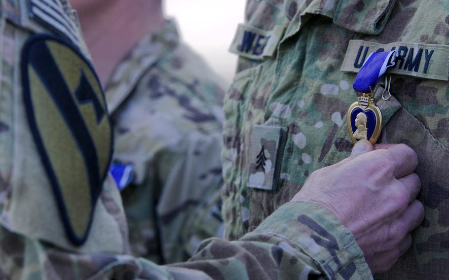 A soldier receives a Purple Heart medal at Forward Operating Base Salerno, Nov. 5, 2011.
