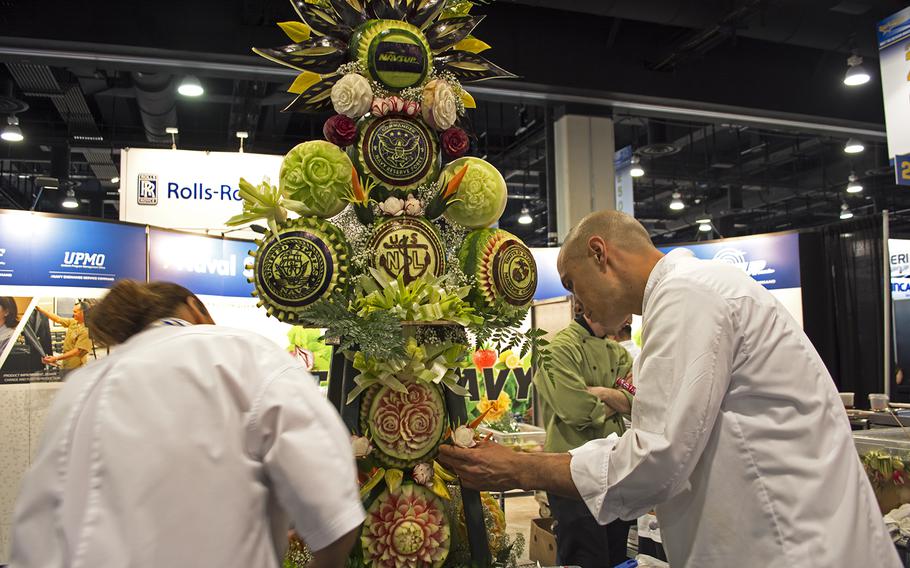A tower of carved fruit decorates the center of the Sea-Air-Space convention in Maryland on April 8, 2014. 