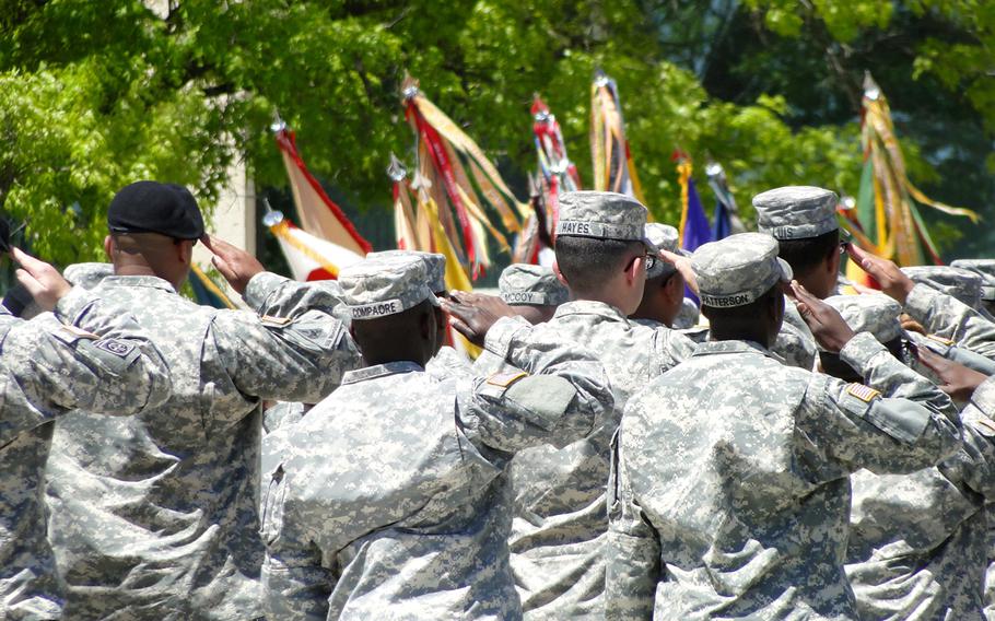Soldiers salute during the National Anthem at the beginning of a memorial service Wednesday at Fort Hood, Texas, in honor of three soldiers killed in the shooting on post on April 2, 2014. 