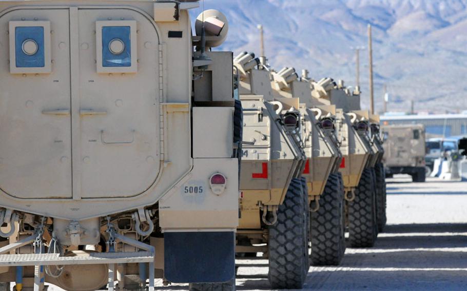 Vehicles belonging to the 1st Stryker Brigade Combat Team, 25th Infantry Division, Fort Wainwright, Alaska, await pickup for a road test at the Northern Training Center, in Fort Irwin, Calif., on Feb. 6, 2011.