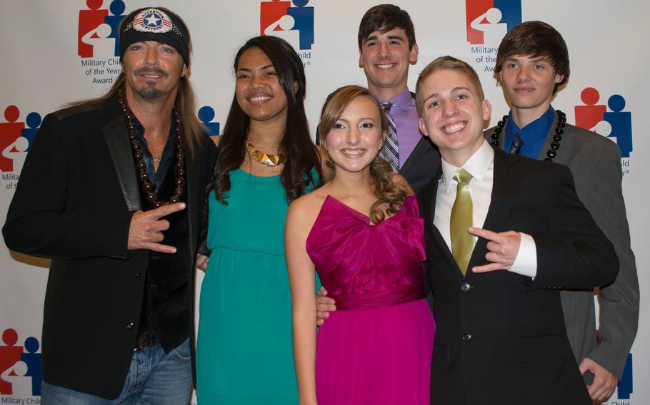 All five recipients – representing each service branch – mug for the camera with Poison lead singer Bret Michaels, far left. From left to right, the teens and their branches are: Juanita Lindsay Collins, Coast Guard; Kenzi Hall, Army; Ryan Patrick Curtin, Navy; Gage Alan Dabin, Air Force; Michael-Logan Burke Jordan, Marine Corps.
