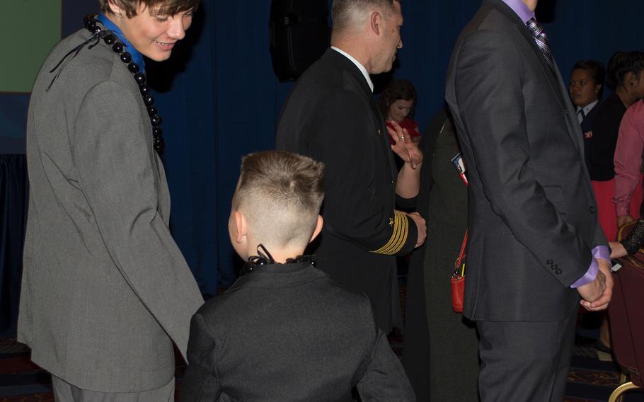 Michael-Logan Burke Jordan, far left, plays with his little brother Jaxson, 8, after the ceremony for receiving the Military Child of the Year award from Operation Homefront on April 10, 2014. Each service branch was honoring a teen, and Jordan was representing the Marine Corps.