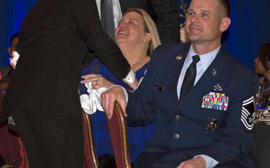Gage Alan Dabin hugs his mother - who had been crying - after receiving the Military Child of the Year award from Operation Homefront.  Dabin, whose father is to the right, was representing the Air Force. 