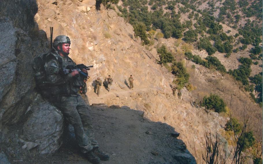 Spc. Kyle J. White rests during the 20-minute climb up the mountain to the trail home to
Bella, just minutes before the Taliban three-pronged coordinated attack on multiple elements of Chosen Company, 2nd Bn., 503rd Inf., 173rd Airborne Brigade.
