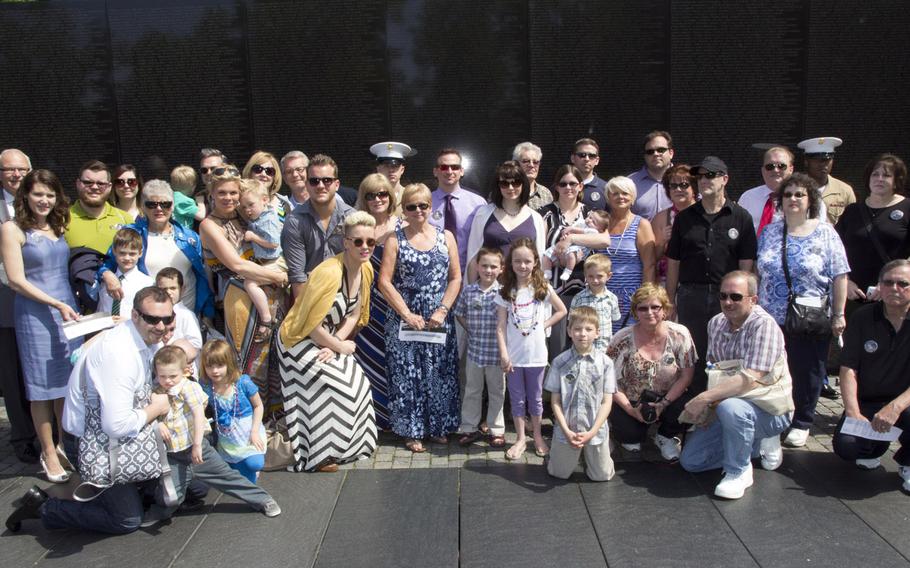Relatives of Pfc. Henry J. Drozdowski Jr. pose for a group photo after a ceremony at the Vietnam Veterans Memorial in Washington, D.C. on May 11, 2014 marking the addition of names to the Wall. Forty-two people were in the Drozdowski group.