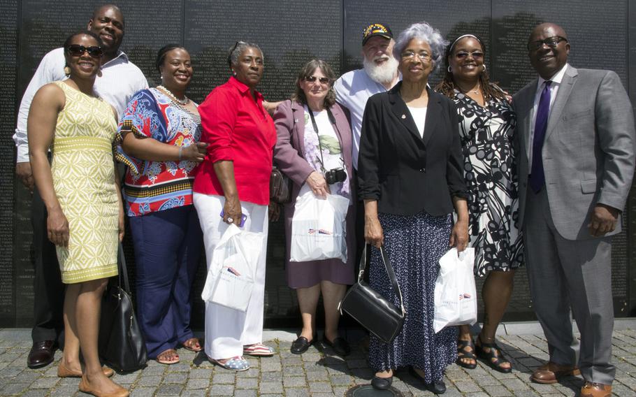 Relatives and friends of the family of Spc. 4 Thomas Charles Littles pose for a photo after a ceremony at the Vietnam Veterans Memorial in Washington, D.C. on May 11, 2014 marking the addition of Littles' and 12 other names to the Wall and the change of status of eight others.