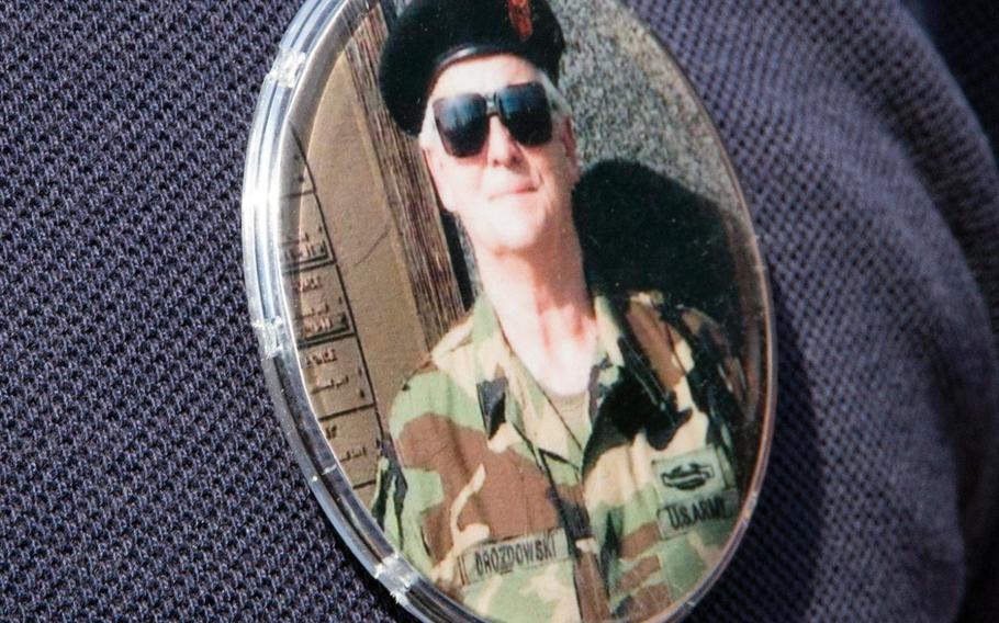 The 42 relatives of Henry J. Drozdowski Jr. who attended a ceremony at the Vietnam Veterans Memorial in Washington, D.C. on May 11, 2014 wore buttons with photos of the Army Pfc. and Vietnam veteran who died in April, 2011.