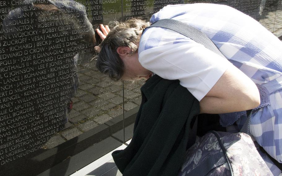 Elizabeth Swiriduk is overwhelmed after seeing the newly-engraved name of her father, Walter H. Mauldin, on the Vietnam Veterans Memorial in Washington, D.C. on May 11, 2014.