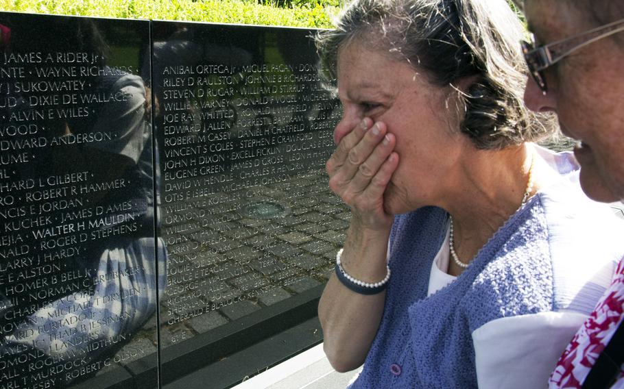 Elizabeth Swiriduk of Tamworth, N.H. is overcome with emotion as she sees the name of her father, Walter H. Mauldin, on the Vietnam Veterans Memorial wall in Washington for the first time on May 11, 2014. Master Sgt. Mauldin, who died in 1968, is one of 13 Vietnam War casualties whose names were added to the wall this year. Eight others had their status changed from missing to deceased, and the addition of a 14th name was delayed until 2015 because of an error.