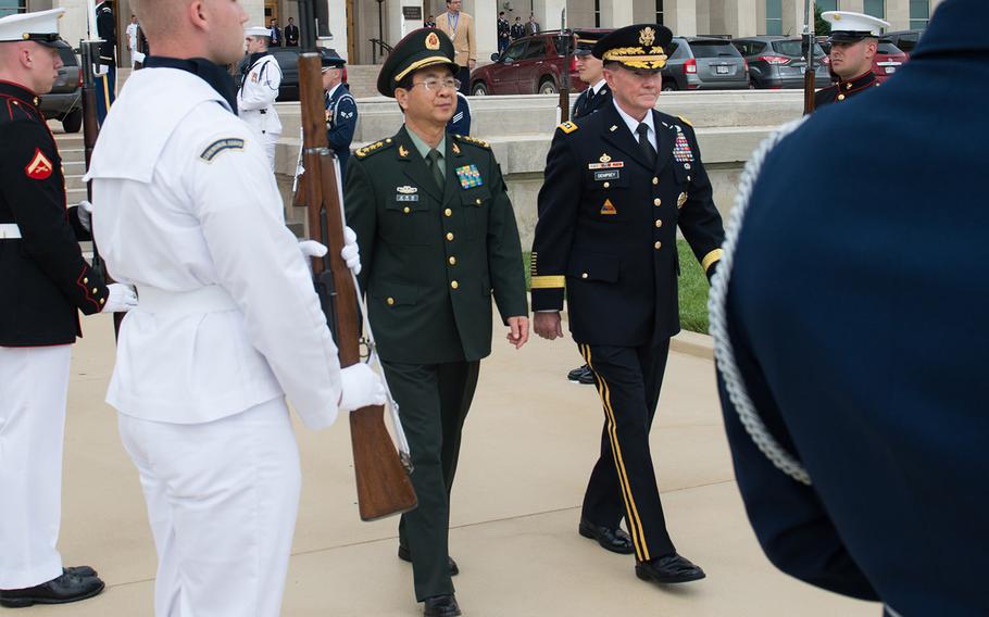 Gen. Martin E. Dempsey, chairman of the Joint Chiefs of Staff, and Chinese Gen. Fang Fenghui, chief of the General Staff of the People's Liberation Army, walk together during a full-honor welcome ceremony at the Pentagon on May 15, 2014. Gen. Dempsey hosted the ceremony, which was the first full-honor ceremony conducted since 2012. 