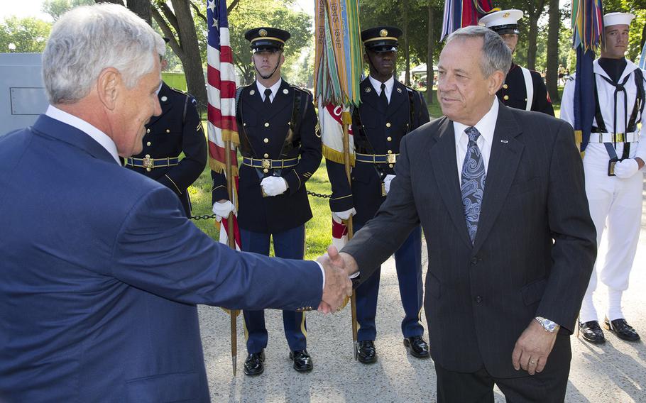 Vietnam Veterans Memorial Fund founder and president Jan Scruggs welcomes Secretary of Defense Chuck Hagel to a May 24, 2012 ceremony in Washington, D.C., to start the reading of the names of all U.S. servicemembers killed in Iraq and Afghanistan.