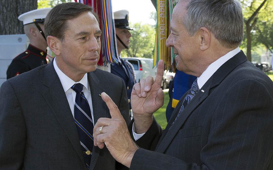 Jan Scruggs, right, founder and president of the Vietnam Veterans Memorial Fund, talks with retired Army Gen. and former CIA director David Petraeus in Washington, D.C. Petraeus and Scruggs were about to take part in a May 24, 2012 ceremony to start the reading of the names of all U.S. servicemembers killed in Iraq and Afghanistan.