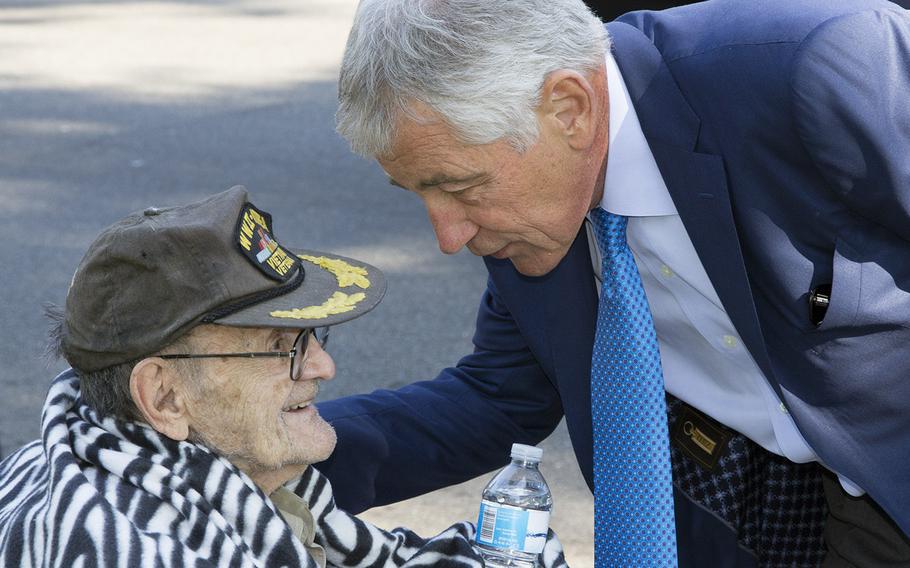 On his way to a ceremony at the Vietnam Veterans Memorial in Washington, D.C., on May 24, 2014, Secretary of Defense Chuck Hagel stops to talk with veteran Peter Ruplenas, from West Virginia. Ruplenas served in World War II. Korea and Vietnam as a combat cameraman.