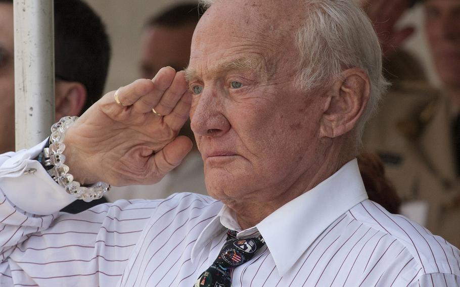 Apollo 11 astronaut Buzz Aldrin salutes during the playing of the national anthem before the National Memorial Day Parade in Washington, D.C., May 26, 2014.
