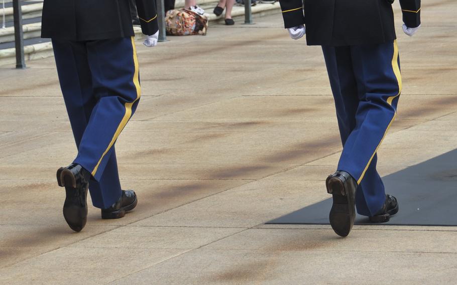 Tomb guards march in sync before a crowd of onlookers during a change-of-the-guard ceremony at Arlington National Cemetery's Tomb of the Unknowns on May 9, 2014.