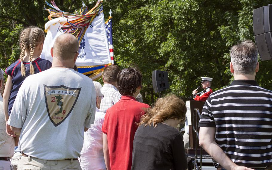 A U.S. Marine sings the National Anthem at the In Memory Day observance in the East Knoll by the Vietnam Memorial Wall on Saturday, June 14, 2014.