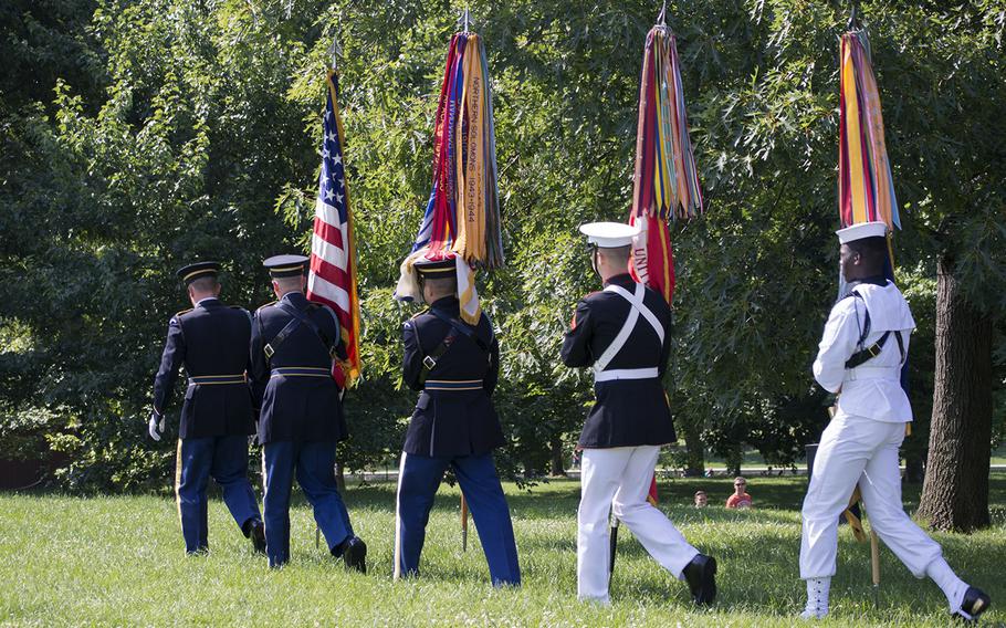 The Armed Forces Color Guard of Washington, D.C., retreat after their presentation during the beginning of the In Memory Day observance at the Vietnam Wall on Saturday, June 14, 2014.
