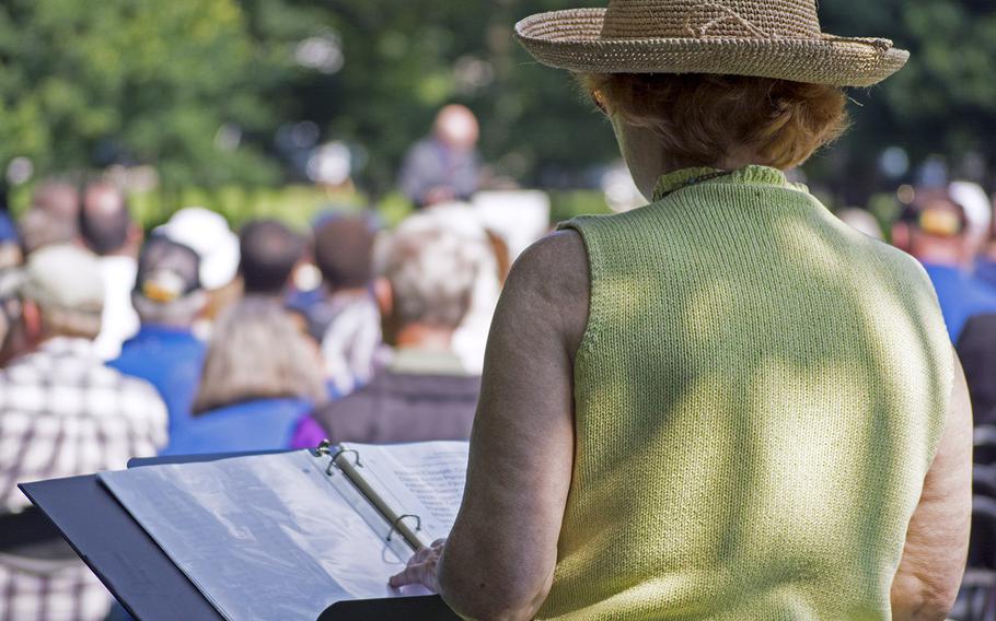 A woman looks over the list of names of honorees being inducted into the In Memory Honor Roll on Saturday, June 14, 2014.