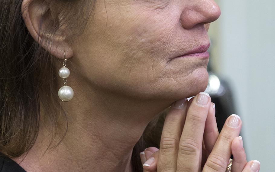 Kyle Carpenter's mother, Robin, listens as her son speaks to reporters in the White House briefing room after his Medal of Honor ceremony, June 19, 2014.