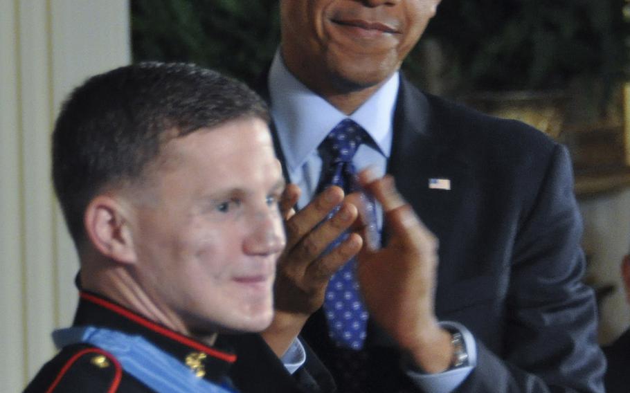 President Barack Obama leads the applause for retired Marine Corps Cpl. Kyle Carpenter after presenting him with the Medal of Honor at the White House, June 19, 2014.