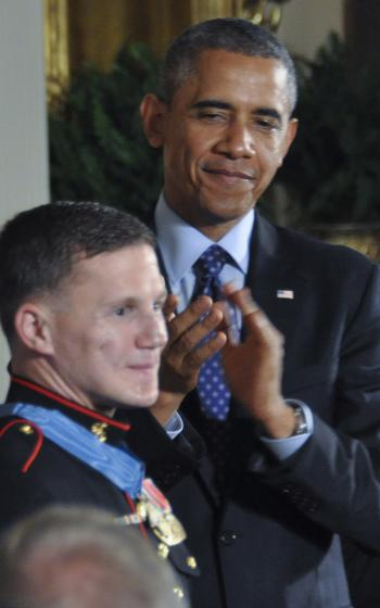 President Barack Obama leads the applause for retired Marine Corps Cpl. Kyle Carpenter after presenting him with the Medal of Honor at the White House, June 19, 2014.