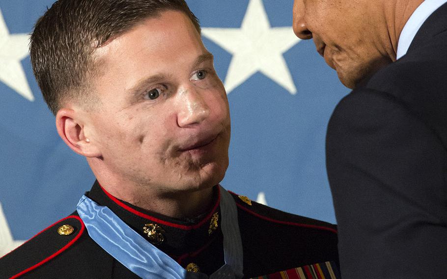 President Barack Obama congratulates retired Marine Corps Cpl. Kyle Carpenter after presenting him with the Medal of Honor at the White House, June 19, 2014.