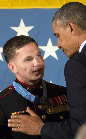 President Barack Obama congratulates retired Marine Corps Cpl. Kyle Carpenter after presenting him with the Medal of Honor at the White House, June 19, 2014.