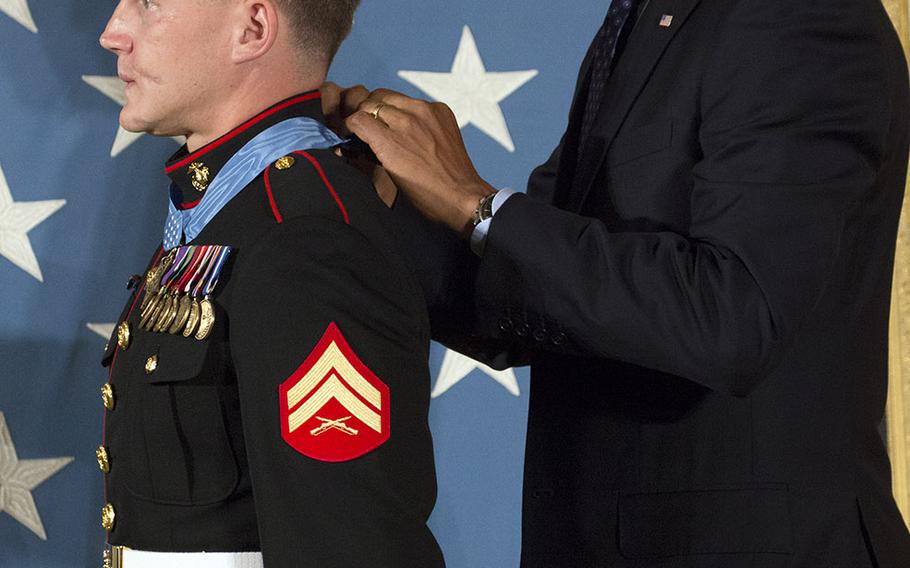 President Barack Obama awards the Medal of Honor to retired Marine Corps Cpl. Kyle Carpenter at the White House, June 19, 2014.