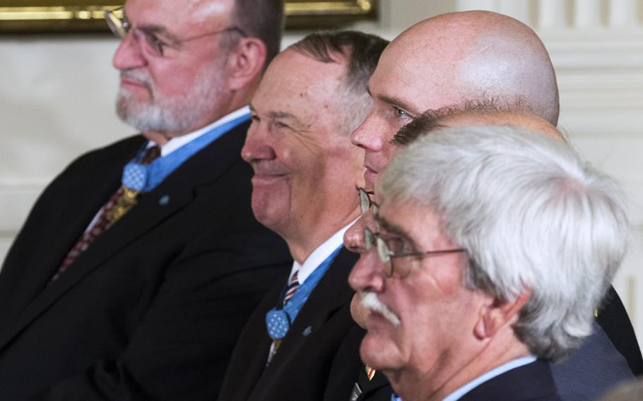 Previous Medal of Honor recipients listen as President Barack Obama speaks at the ceremony for retired Marine Corps Cpl. Kyle Carpenter at the White House, June 19, 2014.