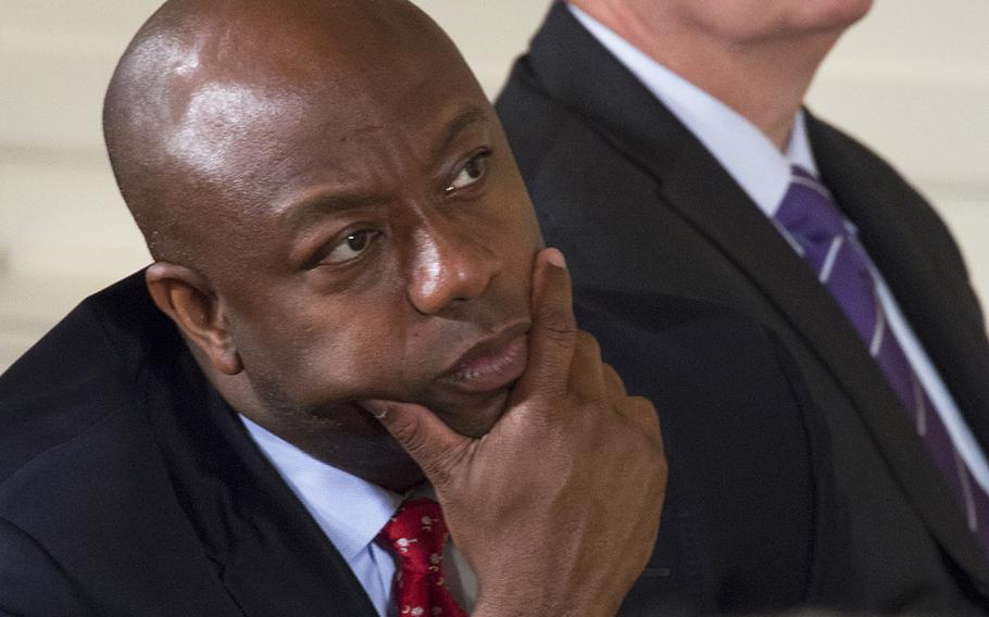 Kyle Carpenter's home-state senators, Republicans Tim Scott and Lindsey Graham of South Carolina, listen as President Barack Obama speaks during the Medal of Honor ceremony at the White House, June 19, 2014.